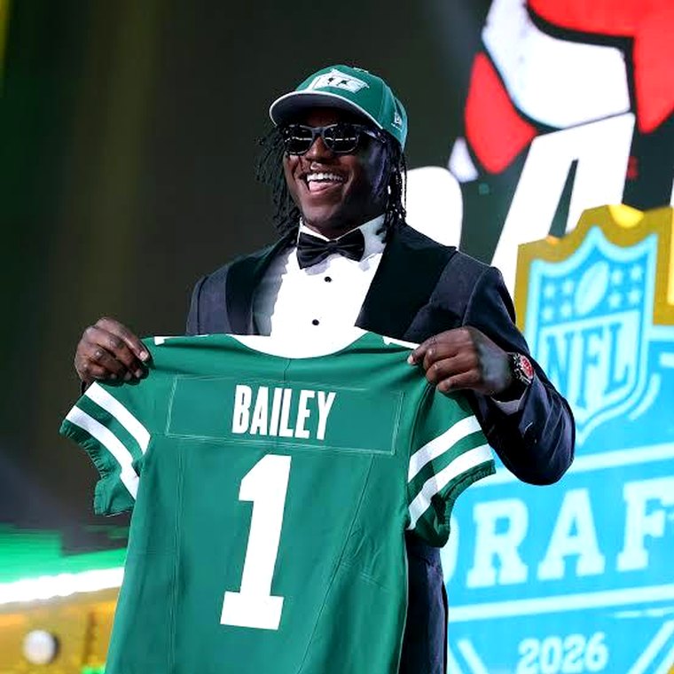 David Bailey holding his New York Jets jersey on draft night