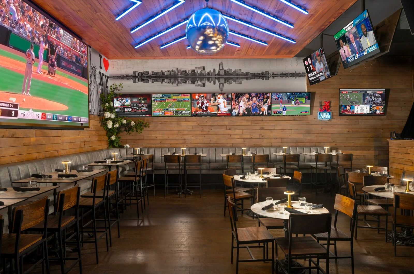 The Ainsworth Midtown interior — screens across every wall