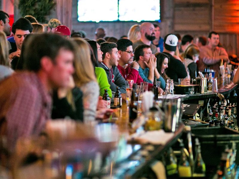 Fans at the bar watching a game