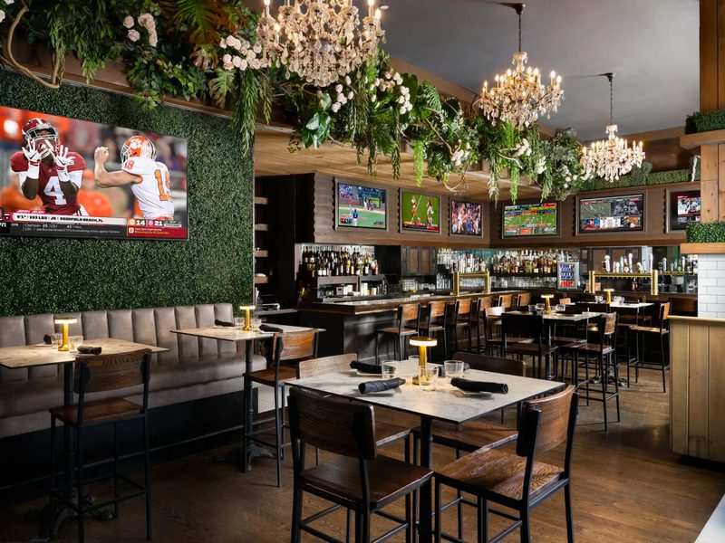 Greenery wall, chandeliers and a wall of screens
