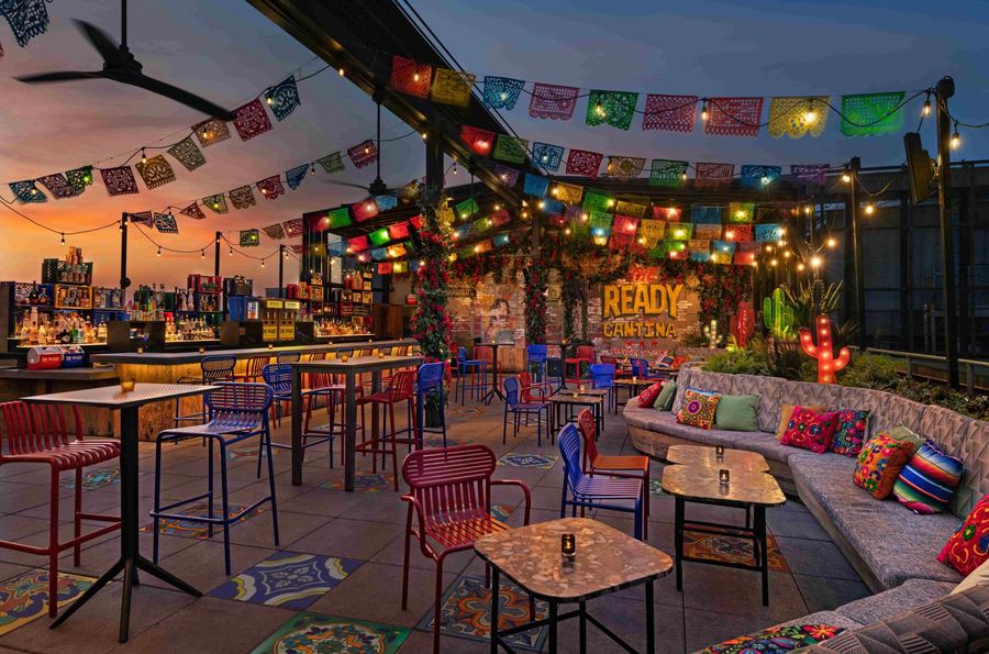 The rooftop at The Ready Cantina at sunset, under papel picado and string lights